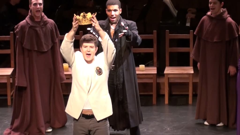 A spirited theatrical performance with a student raising a crown
