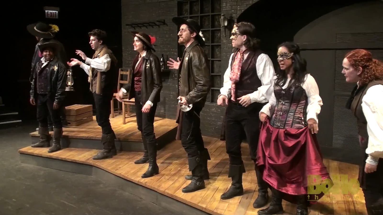 A group of actors in steampunk attire taking a bow on stage